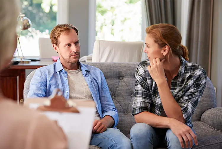 A woman talks with her partner during couples counseling